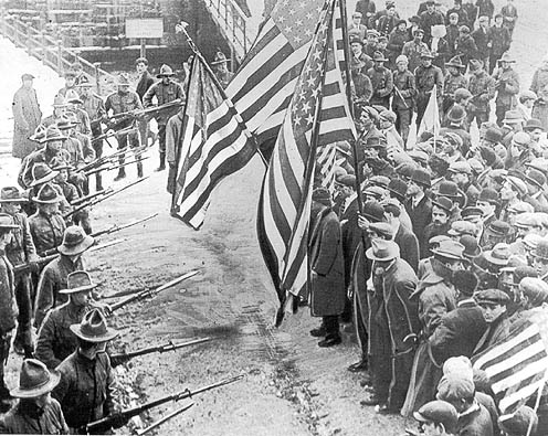 Massachusetts militiamen with fixed bayonets surround a group of strikers during the Lawrence, Massachusetts Textile Strike of 1912