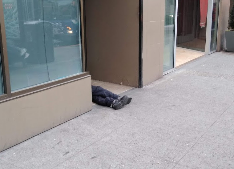 Homeless man sleeping in doorway